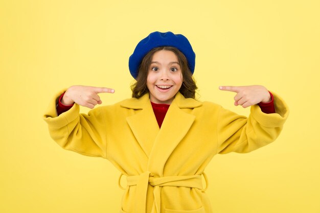 Place for ad advertisement Child promoting something yellow background Girl pointing index fingers herself Advertising product Look at this Advertisement launching product Advertisement concept