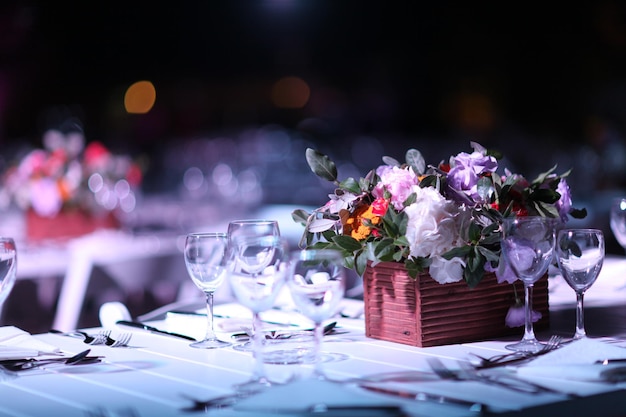 Photo place setting and bouquet on table at wedding reception