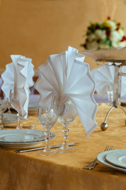 Place setting at laid restaurant table in beige colours