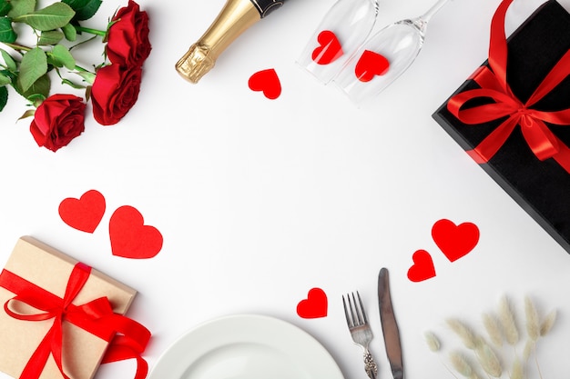 place setting, roses and presents on white table