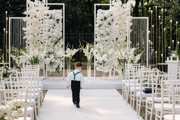 A place for a wedding ceremony on the street and a boy walking along the path. Decorated wedding venue