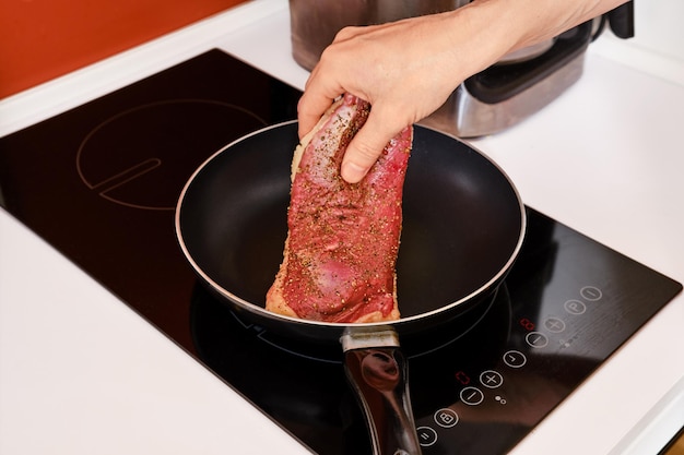 Placing duck breast in a frying pan