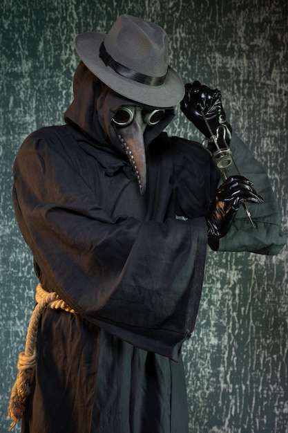 Photo plague doctor with a syringe of medicine or poison