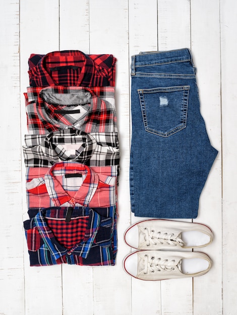 Plaid shirts, blue jeans and white sneakers