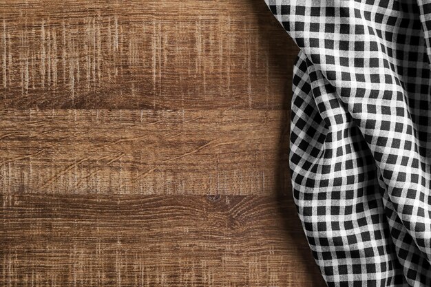 Plaid textile on wooden background Fabric texture