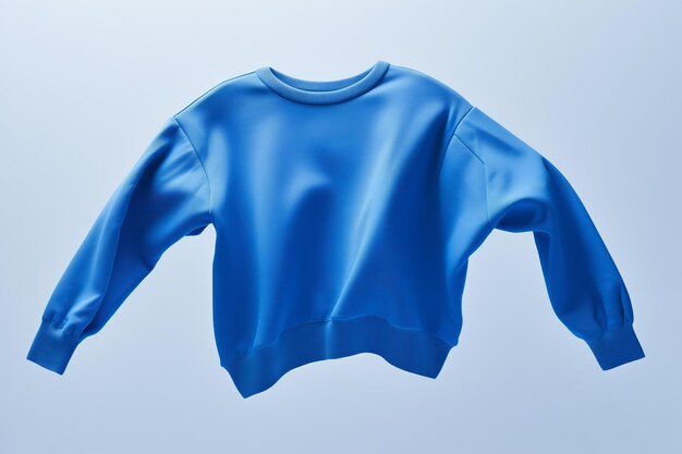 A plain blue sweatshirt floating on a plain background