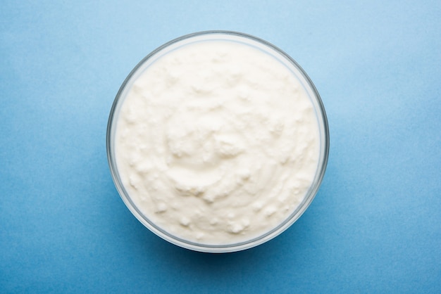 Plain curd or yogurt or Dahi in Hindi, served in a bowl over moody background. Selective focus