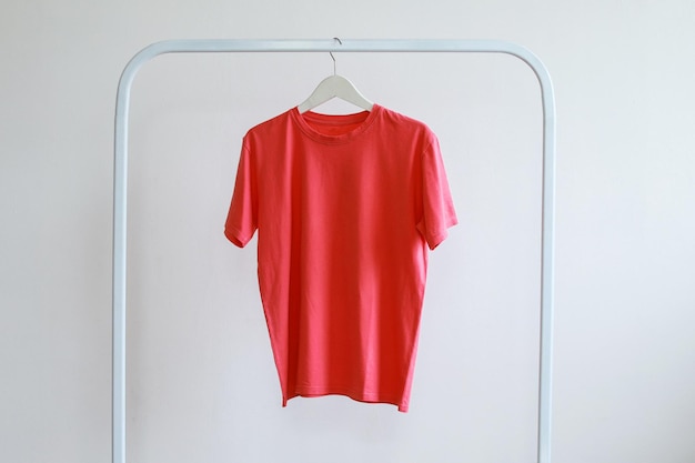 Plain round neck pink tshirt hanging on rack clothes