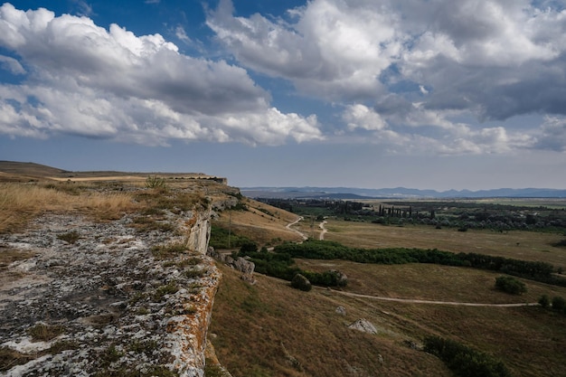 Plain and steppe with dry grass under a blue sky against background of mountains in Crimea