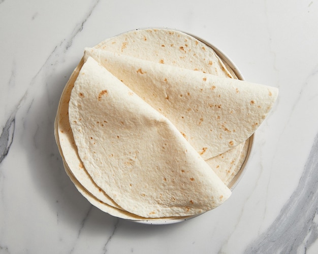 Plain tortilla wrap on white background from above