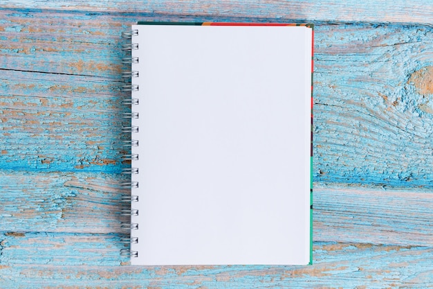 Plain white notepad on a wooden background