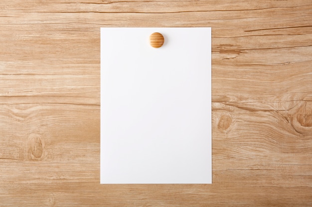 A plain white paper placed on a wooden board