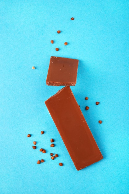 Plakjes gezonde boekweitchocolade voor kinderen op een blauwe achtergrond