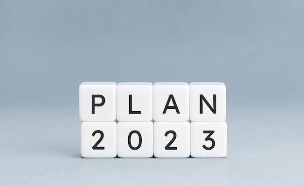 Plan 2023 message on cube blocks isolated on blue background Copy space