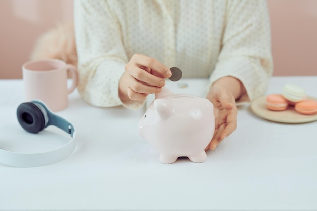 Photo plan finance and savings moneyyoung women put money coin in piggybank and calculate cost