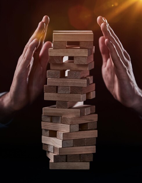 Plan and strategy in business Risk To Make Business Growth Concept With Wooden Blocks hand of man has piling up and stacking a wooden block