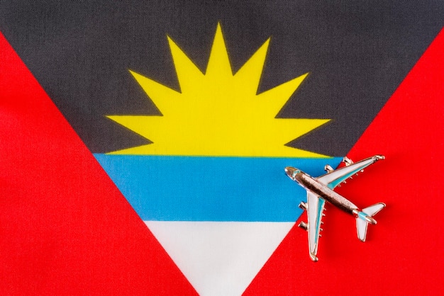 Plane over the flag of Antigua and Barbuda travel concept