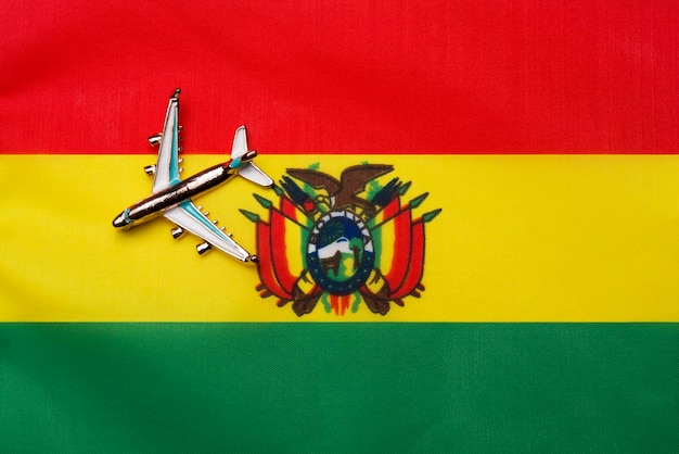 Plane over the flag of bolivia the concept of travel and tourism