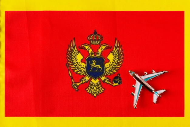 Plane over the flag of Montenegro travel concept