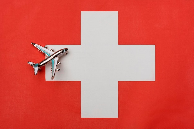 Plane over the flag of Switzerland the concept of journey