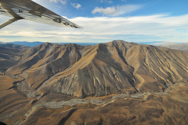 Plane flies over the mountains