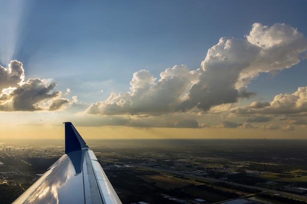 The plane is taking off during a colorful sunset