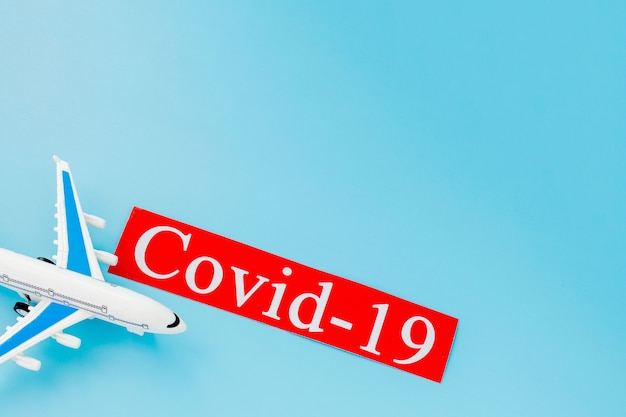 비행기 모형 장난감과 COVID-19 텍스트 개념. 코로나 바이러스 영향으로 인한 항공편 취소.