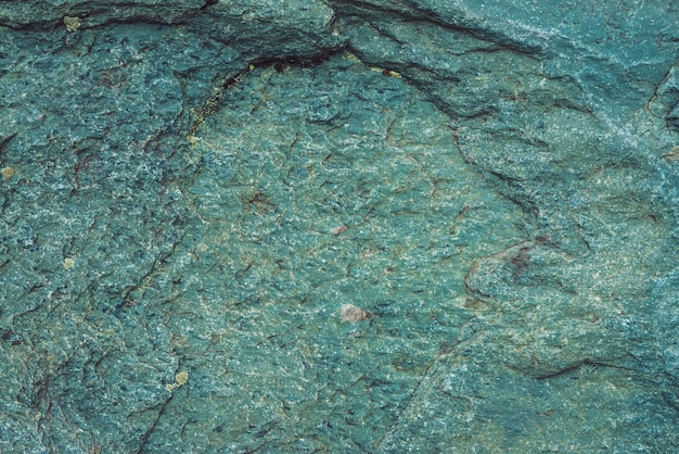 Plane of multicolored boulder in macro. Beautiful rock surface close up. Colorful textured stone.