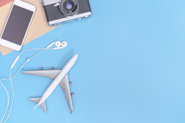 Plane and travel objects on blue copy space for poster