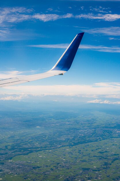 A plane wing is shown from the air with the tip of the wing.