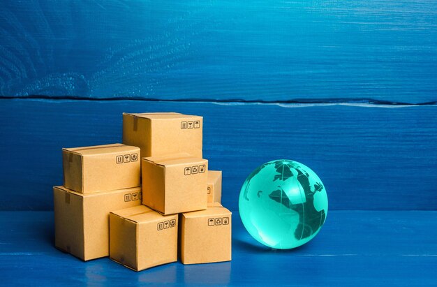 Photo planet earth globe and boxes global business and world trade distribution of goods import