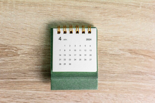 Photo planning calendar for april 2024 on a wooden background