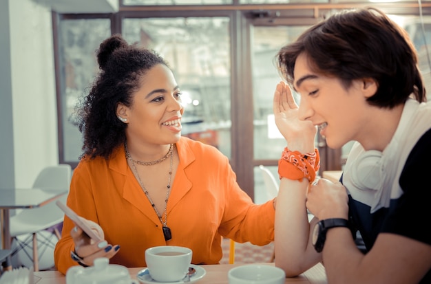 Planning weekends. Friends planning trip together while sitting in a cafe