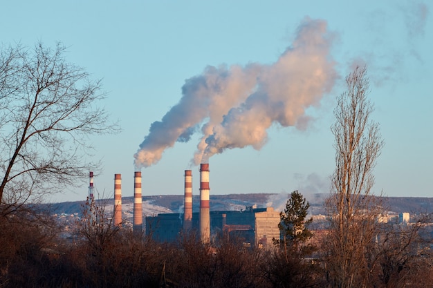 The plant emits smoke and smog from the pipes