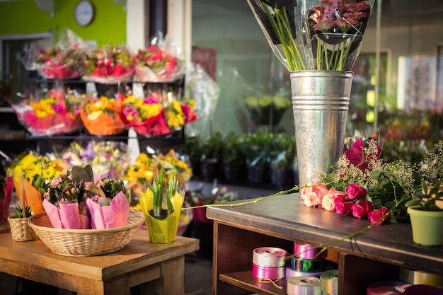 Plant pots and bouquet on table