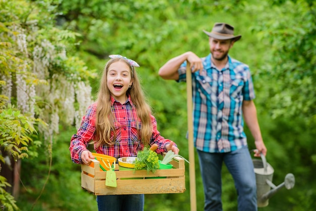 Planting flowers Phases of moon help determine best time plant garden Transplanting vegetables from nursery gardening center Plant veggies Planting season Family dad and daughter planting plants