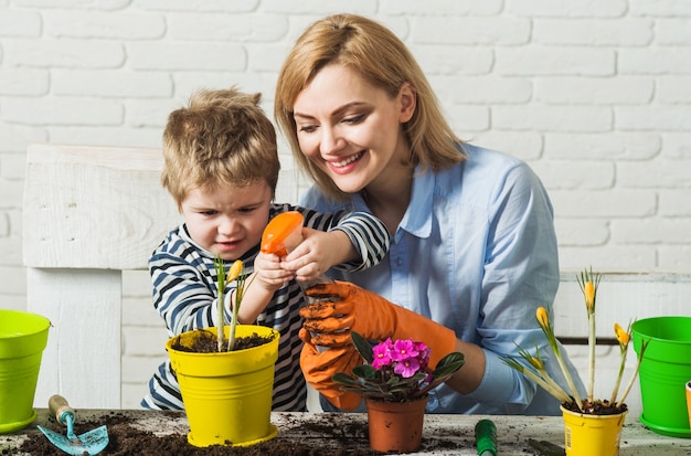 Planting together. Mother and son planting flower. Family relationships. Care for plants. Gardening.