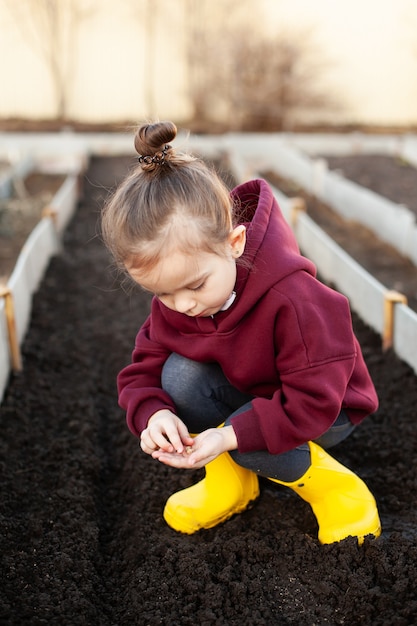 Planting vegetables A child in a cottage in the village A vegetable garden and a garden