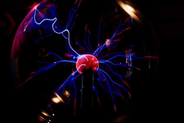 Plasma ball with energy rays on dark background