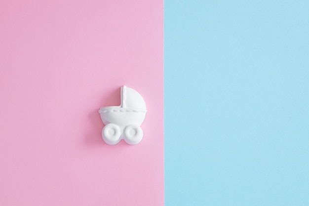 A plaster figure of a baby carriage on a colored background