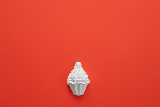 A plaster figure of a cake on a colored background