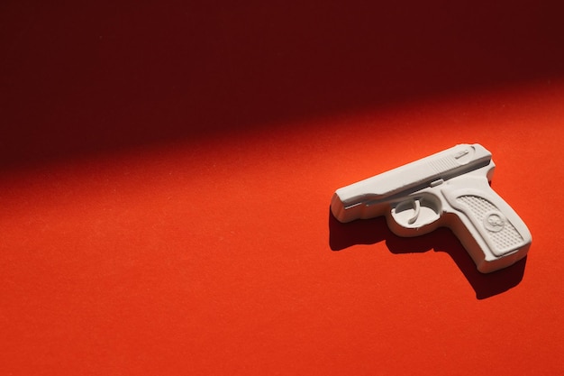 Plaster figure of a gun on a colored background