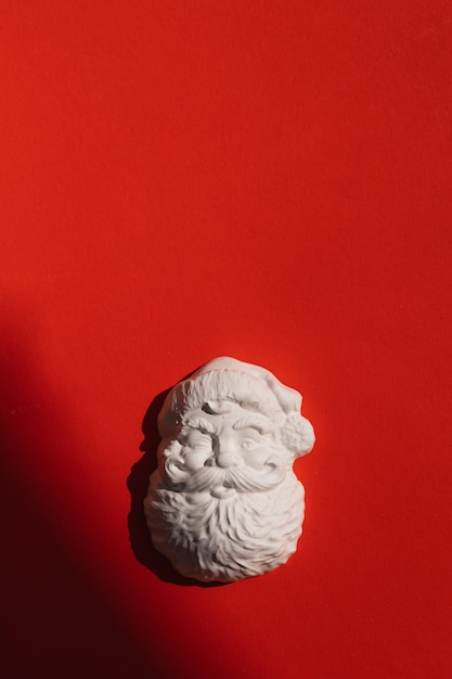 Plaster figure of Santa Claus on a colored background