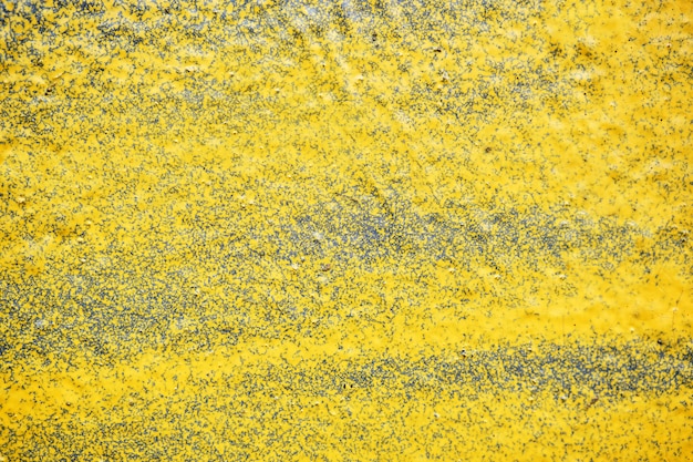 The plaster wall is painted with a yellow spray. Background