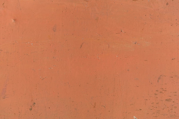 Plastered brick wall painted in orange color vintage style background and texture.