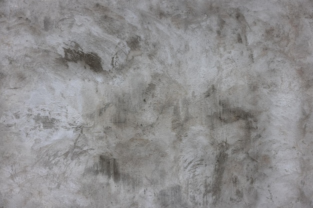 Plastered grey concrete wall surface as a seamless texture and full frame background