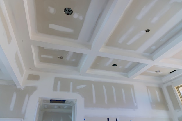 plastering gypsum drywall seams on the walls and ceiling of a newly house on process
