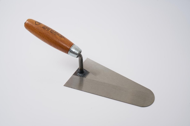 Plastering trowel with a wooden handle on a white background