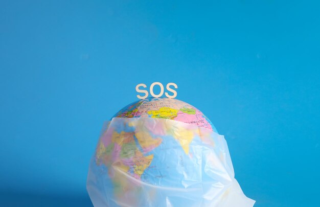 Plastic bag ban say no plastic pollution zero waste recycle\
globe wrapped in a plastic bag