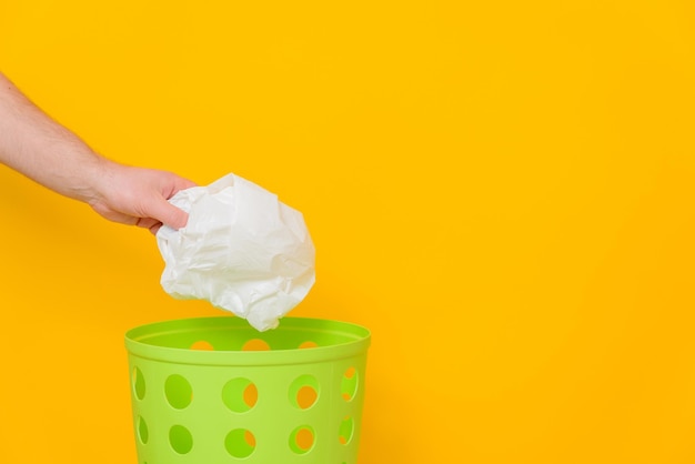 The plastic bag is thrown into the wastebasket